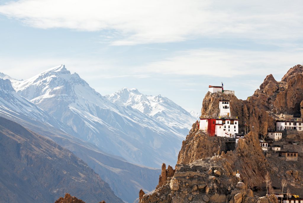 Tibetan Buddhist monastery Dhankar Gompa (3894 m) on the background of snow-capped peaks. Spiti valley, Himachal Pradesh, India.